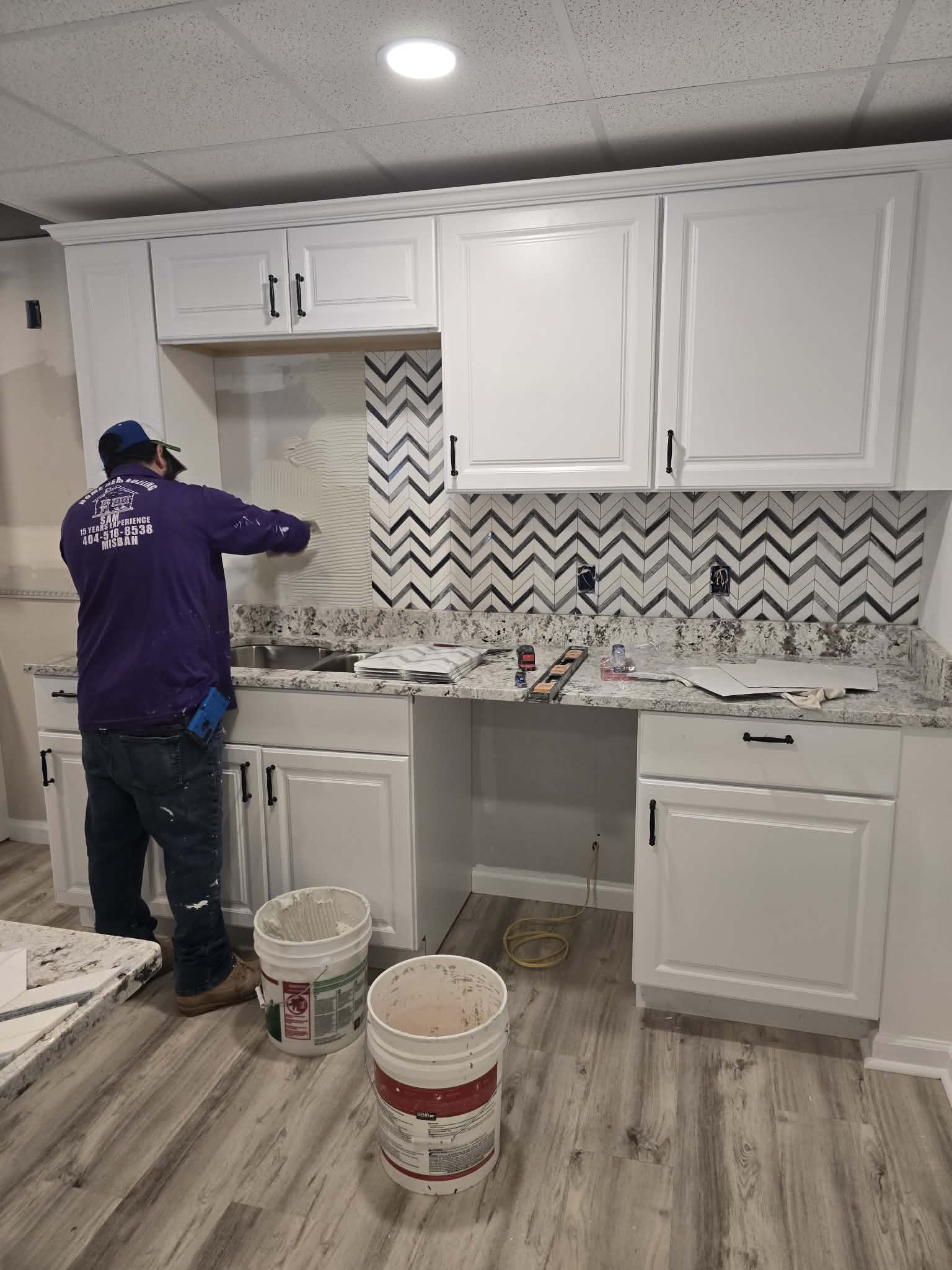 Kitchen renovation in progress, installing chevron backsplash tile