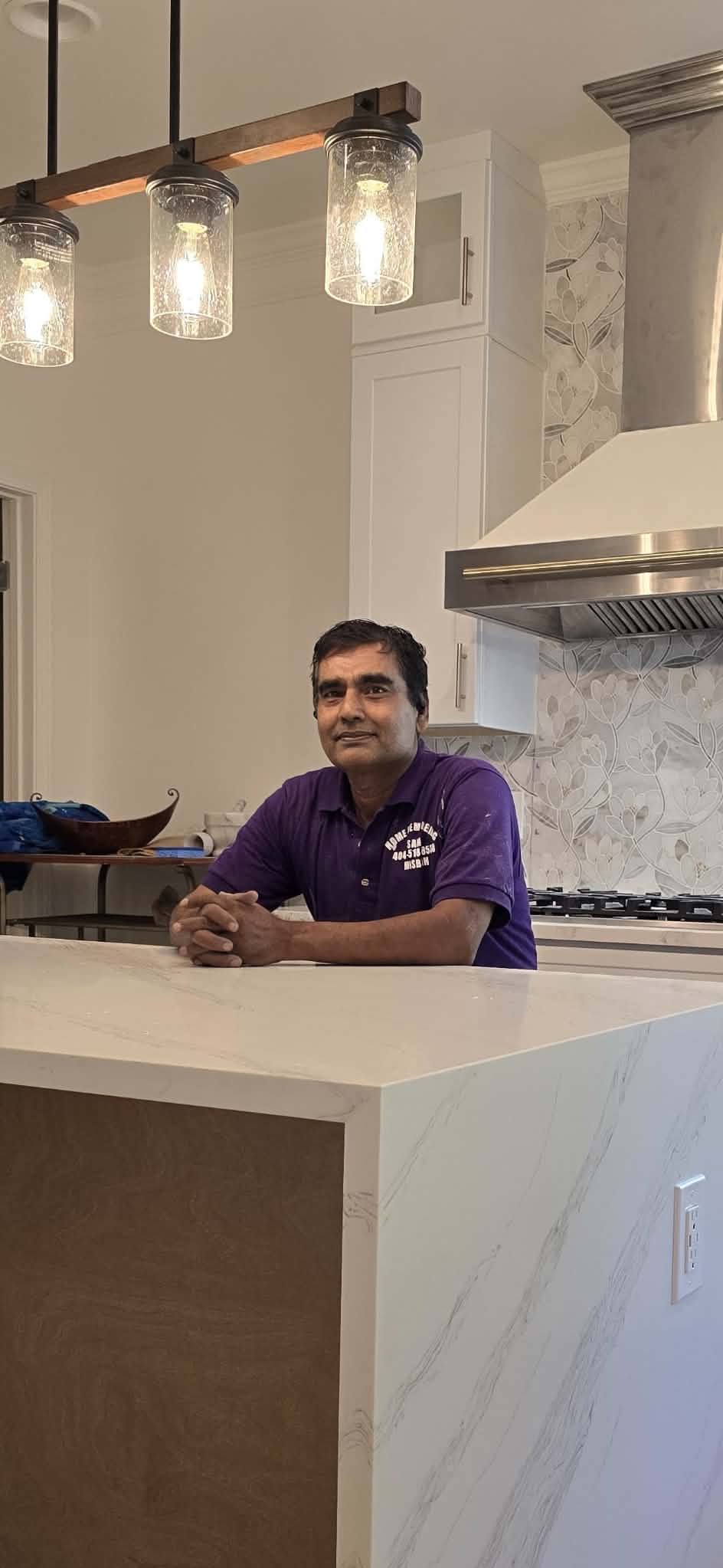 Owner of ATLGA Renovation Corporation in a completed kitchen remodel